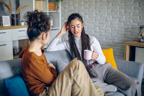 istock Two roommates are having a conversation in the living room 2202998086