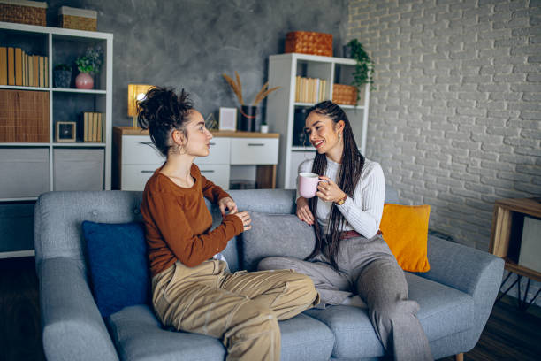istock Two roommates are having a conversation in the living room 2202998156