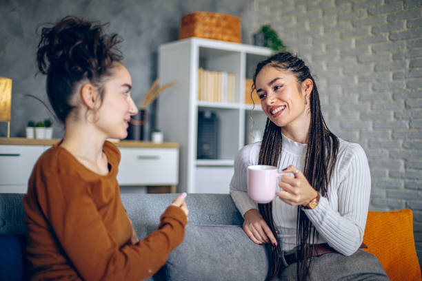 istock Two roommates are having a conversation in the living room 2202998295
