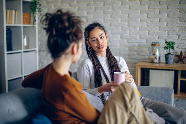 Two roommates are having a conversation in the living room