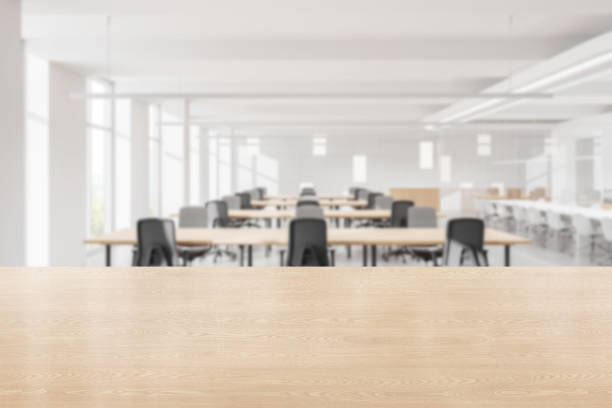 istock Modern open-space office interior with large windows, cityscape view, and rows of desks and chairs. 3D Rendering 2202998512