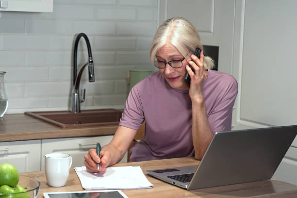 istock Remote work: a mature woman combines calls and appointments 2203000112