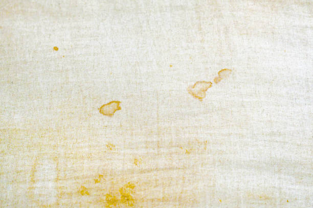Dirty old pillow with yellow stains. Unclean mattress fabric clothes.