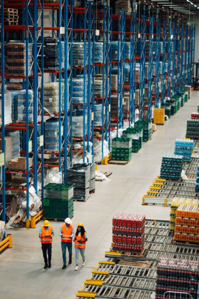 istock Warehouse workers walking and controlling inventory with digital tablets and walkie talkie 2203001459