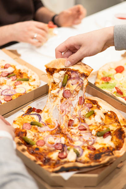 istock Pizza with mozzarella cheese topped with sliced onion, sausage with pickles. 2203002369