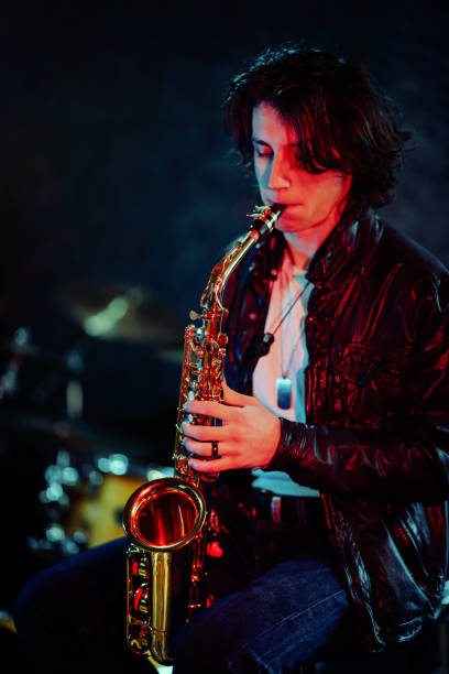 istock Young saxophone player rehearsing alone in the studio 2203003051