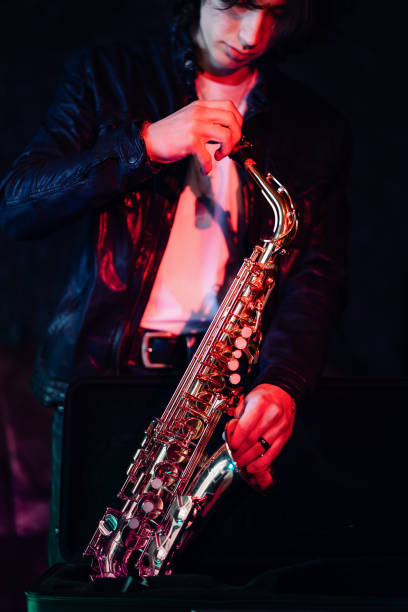 istock Young saxophonist preparing his saxophone before a jam session 2203003060