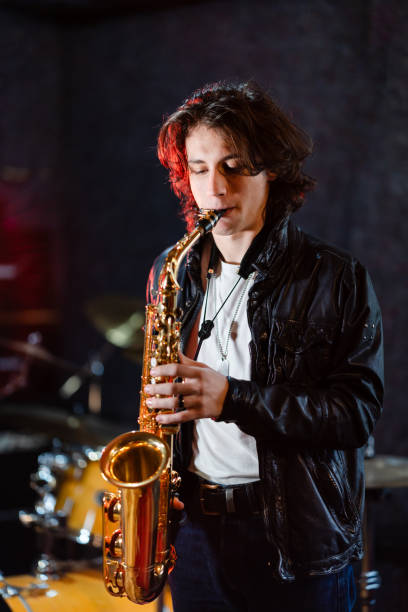 istock Young saxophone player rehearsing alone in the studio 2203003199