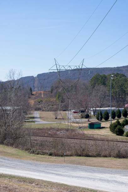 istock Electric lines through a rural hillside 2203004047