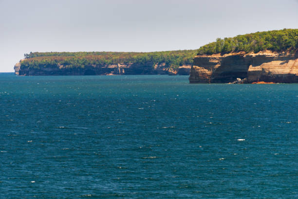 close-up view of the iconic sea caves at Meyers Beach, captured from the water during a serene sunset