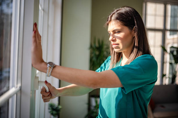 Young female nurse wearing scrubs engages in focused work inside a hospital setting