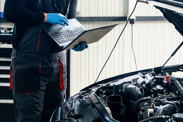 istock Serviceman with laptop checks car software in car service. 2203004755