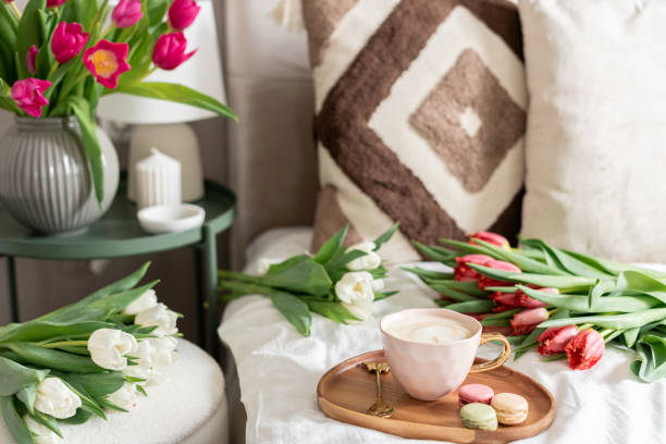 istock Cup with cappuccino and macarons, spring flowers tulips, morning concept, woman's day 2203004871
