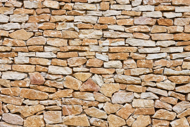 istock Stone textured wall in brown color. Natural rocky background. Horizontal 2203005094