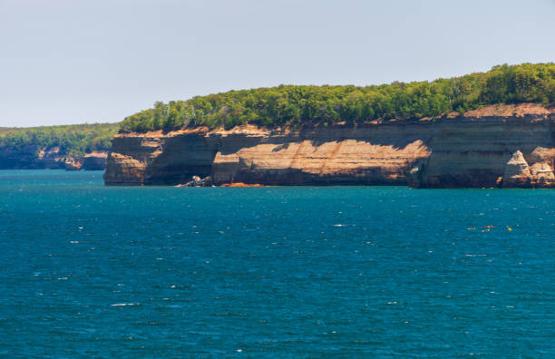 Shallow depressions filled with water on the rocky shore of Grand Marais, Minnesota, USA