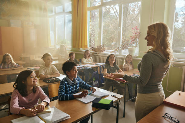 istock Happy students enjoying in lecture by their elementary teacher. 2203006866
