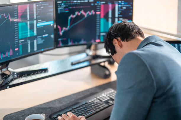 istock Frustrated Asian Stock Broker in Modern Office Setting 2203007462