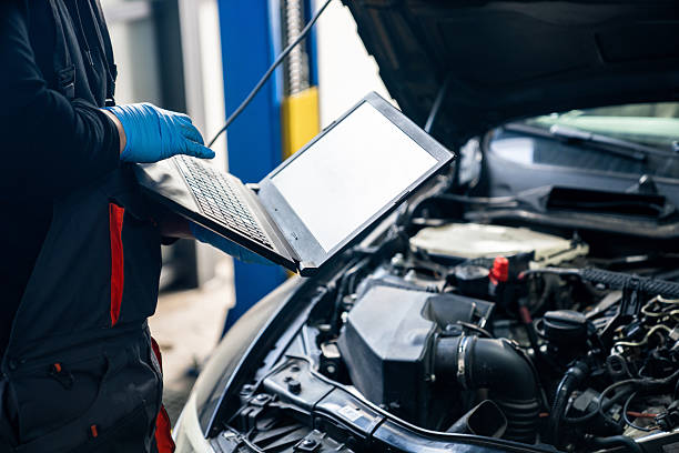 istock Serviceman with laptop checks car software in car service. 2203007592