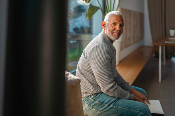 istock Mature Hispanic Male Sitting by a Sunlit Window 2203008307