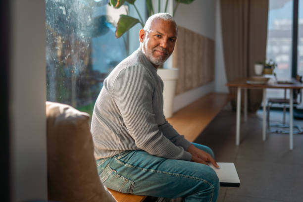 istock Mature Hispanic Man Sitting in Bright Cozy Room 2203008310