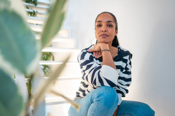 istock Confident Hispanic Woman Sitting on Bright Staircase 2203008317