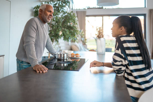 istock Hispanic Father and Daughter Sharing Moment in Modern Kitchen 2203008369
