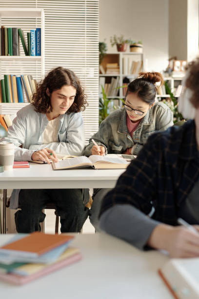 istock Two Students Enjoying Work at Desk in College Class 2203010569