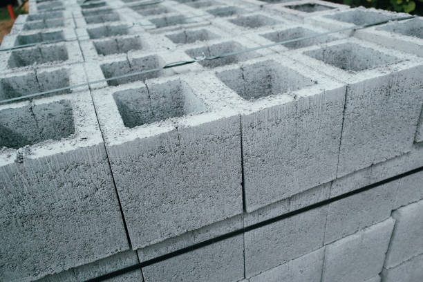 istock Construction concrete block. Industrial production of building cement pressed materials. Concrete Cinder Blocks. Vibration-pressed hollow building block. 2203010613