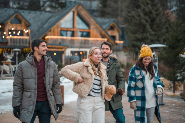 istock Cheerful Caucasian Couples in Cozy Winter Wonderland Setting 2203010846