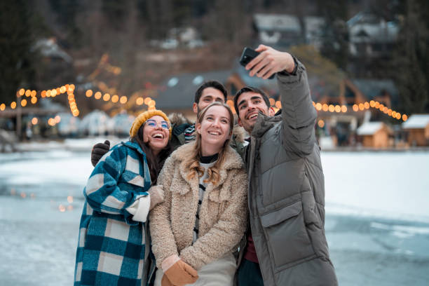 istock Joyful Caucasian Couples Taking Selfie in Winter Wonderland 2203010886