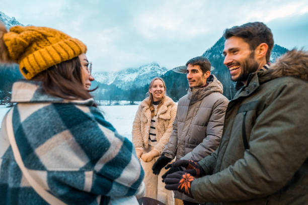 istock Two Caucasian Couples Smiling in Snowy Winter Scenery 2203011009