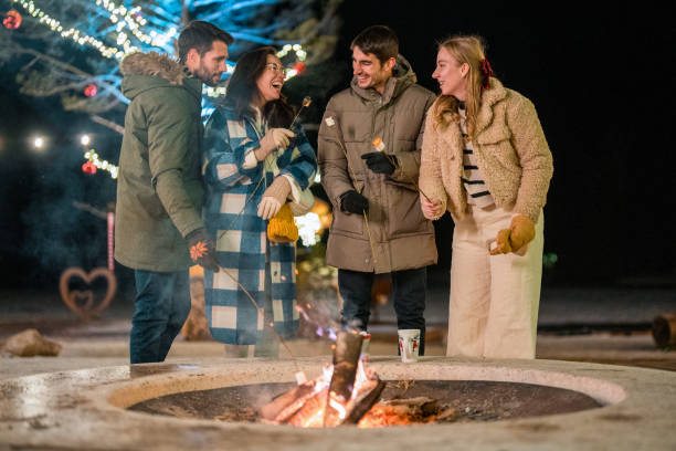 istock Young Adults Enjoying Winter Firepit in Cozy Attire 2203011025