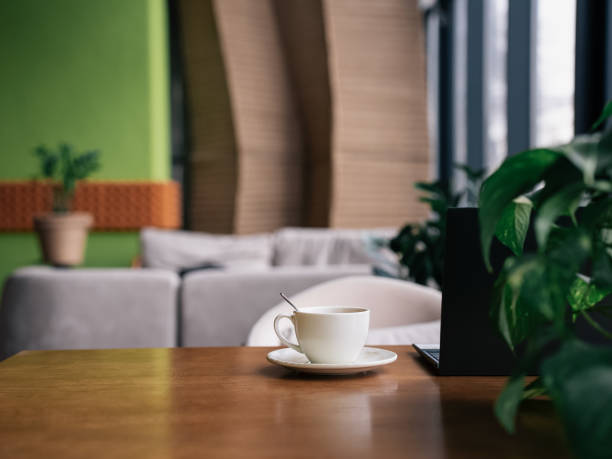 Warm cup of coffee on a wooden table in a modern cafe setting