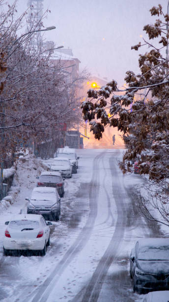 istock Romantic view of heavy snowfall with street lights. 2203012376