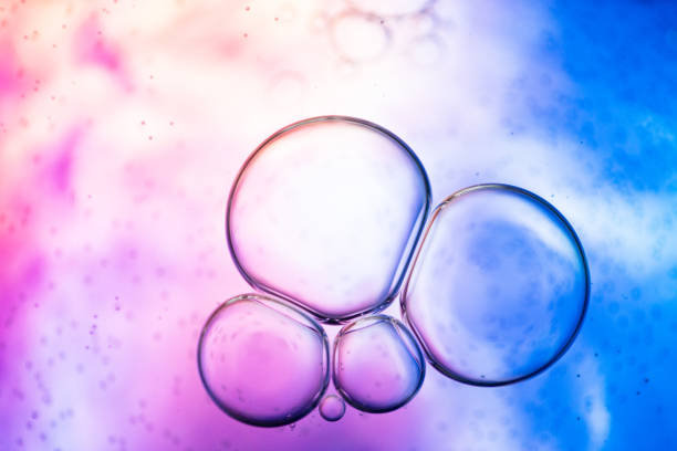 istock Colorful Oil Bubbles Floating in Abstract Purple and Blue Liquid 2203012930