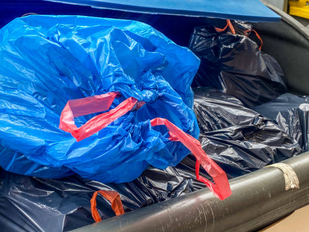 istock Blue garbage bag in plastic container in the street 2203015676