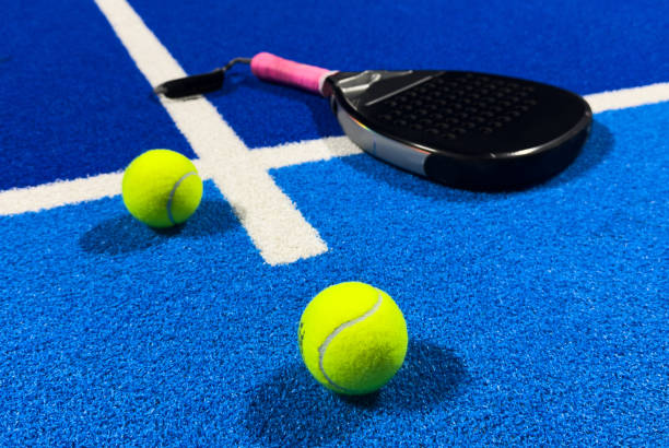istock Paddle racket with a ball. Padel court 2203017316