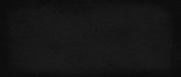 istock Black colored old paper texture with matt fibrous structure. Dark grunge rough background to be used as blackboard for educational projects. Blank chalkboard, ready for sketches, copy paste sheet. 2203017928