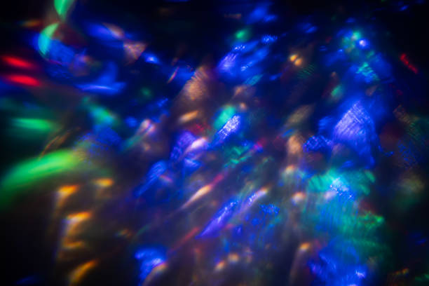 Colorful light leak on black background, abstract design with optical lens flare shot on a long lens.
