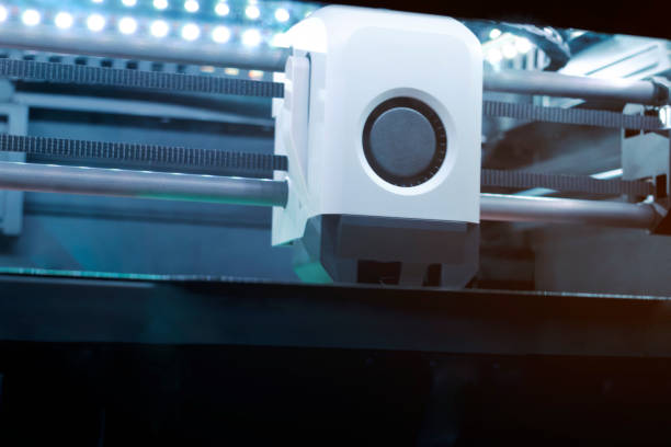 istock A 3D Printer Works Diligently in a Contemporary Workshop, Showcasing Intricate Designs and the Application of Advanced Technology. Tools and Materials Surround the Printer, Highlighting Innovation. 2203018248