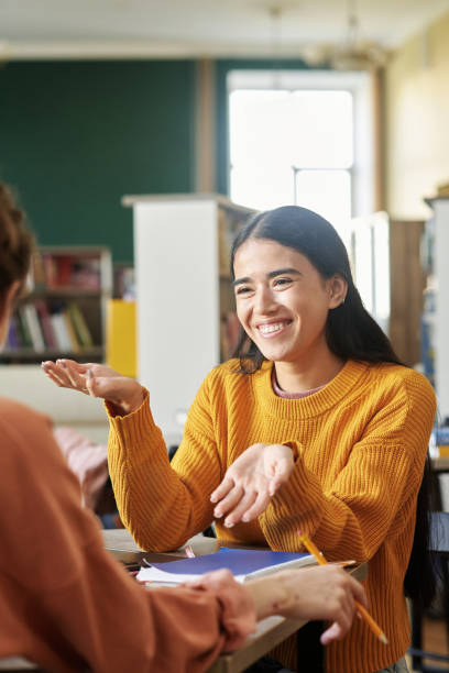 istock Smiling Woman Engaging in Conversation at Desk 2203018573