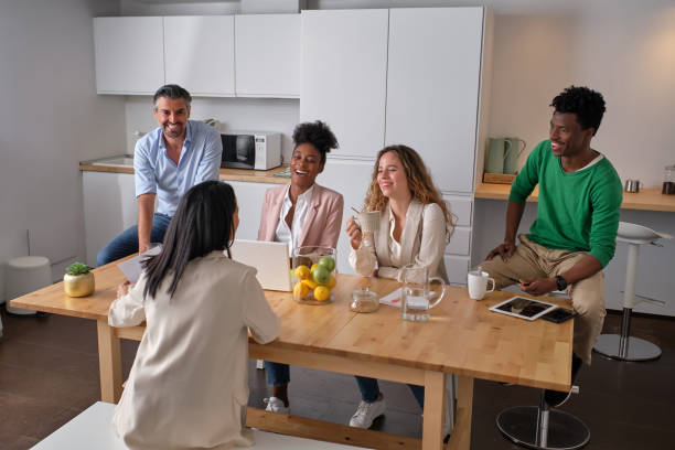 istock Company of multiracial colleagues working in kitchen in office 2203020575