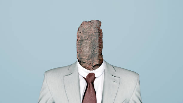 istock Man in Gray Suit with Brick Head  Stubbornness, Mental Block, and Rigidity, 3D Render 2203024176