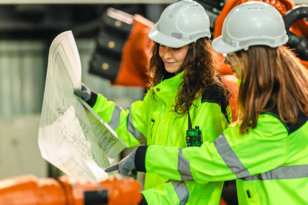 istock Engineer Reviewing Blueprint in Robotic Facility 2203024586