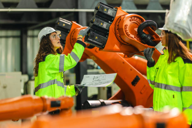 istock Engineer Reviewing Blueprint in Robotic Facility 2203024628