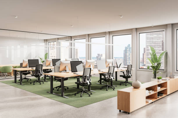 istock Modern open-plan office interior with wooden desks and ergonomic chairs. 3D Rendering 2203027984
