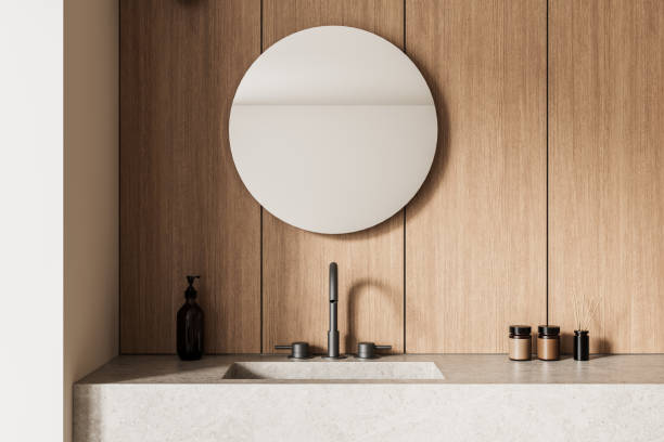 istock Minimalist bathroom interior with round mirror and wooden paneling. 3D Rendering 2203028601