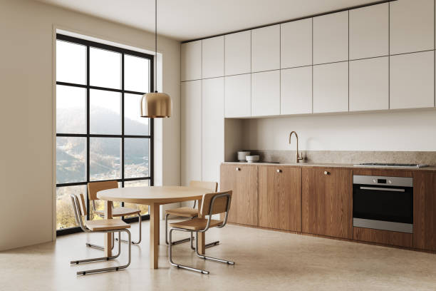 istock Modern kitchen with wooden cabinets and dining area in natural light. 3D Rendering 2203029122