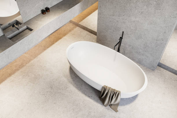 istock Elegant white oval bathtub on stone flooring in minimalist bathroom. 3D Rendering 2203029355