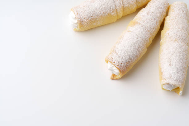 Delicious cream-filled pastries rolling on a smooth surface ready to be enjoyed